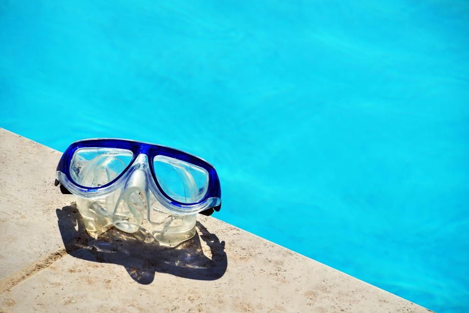 The outdoor swimming pool with loungers alongside