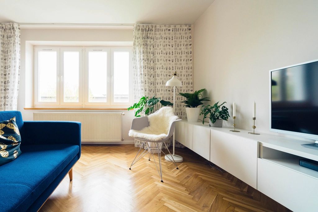 A guest room with a large bed and soft lighting